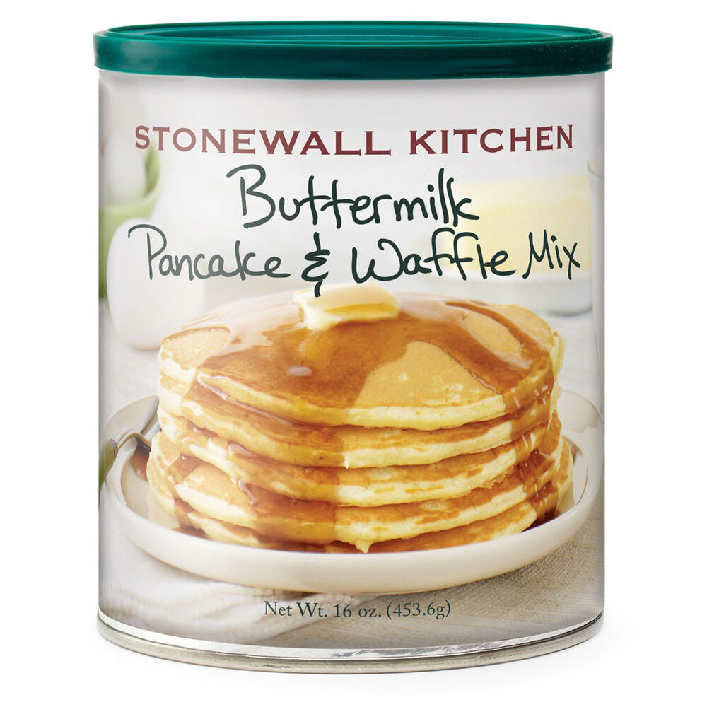 A cylindrical container of STONEWALL KITCHEN - BUTTERMILK PANCAKE AND WAFFLE MIX features a label showing a stack of golden pancakes topped with syrup on a white plate. Perfect for both pancakes and waffles, the net weight is 16 ounces (453.6 grams), and the container has a teal lid.