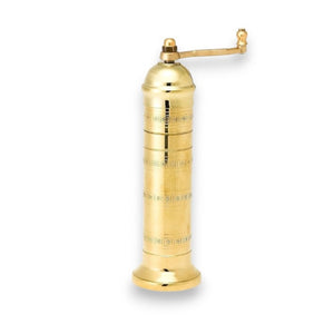 The ATLAS BRASS SALT MILL 9" by PEPPER MILL IMPORTS is a tall, elegant handcrafted Greek product with a cylindrical design and detailed engravings. It includes a top crank handle for grinding and boasts a sleek, polished finish against a white background.