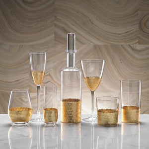 A collection of six 260 ml FEZ CUT GLASS CHAMPAGNE FLUTE WITH GOLD LEAF vessels, including various drinking glasses and a decorative bottle, each featuring a textured gold-leaf honeycomb pattern at the base.