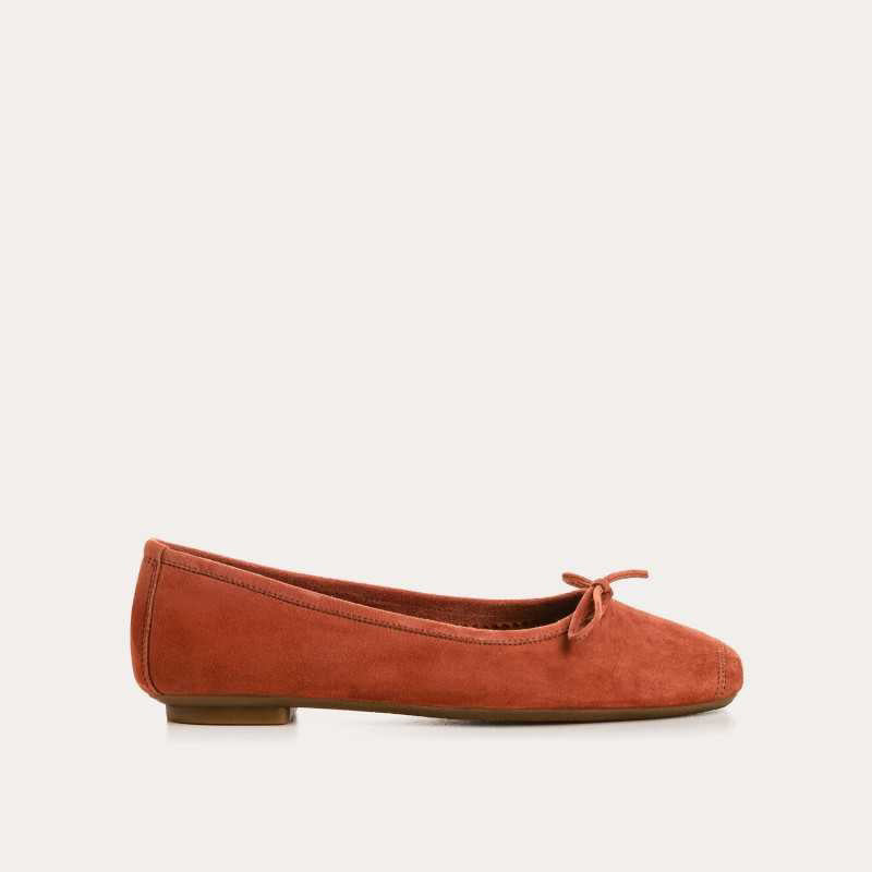 The REQINS - HARMONY Suede Ballerina Flat in Brique is shown in soft suede goatskin with a small bow on the toe, displayed side view against a plain white background.