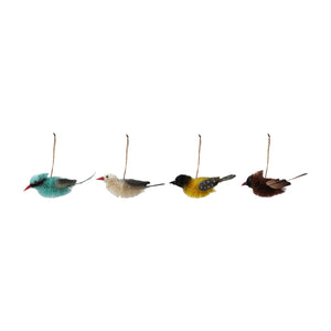 Four assorted CREATIVE COOP SISAL BIRD ORNAMENTS are arranged on vintage garden paper, accented with moss and a small box for added texture and charm.