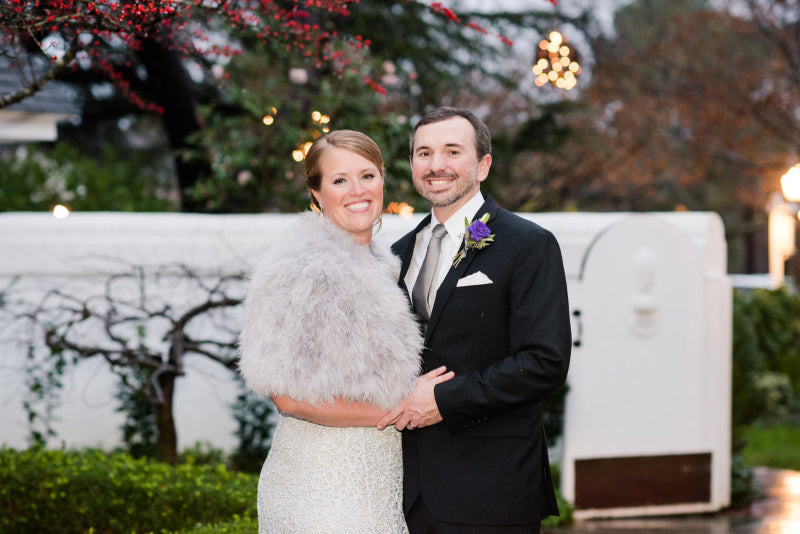 Couple posing together outdoors with a blurred background