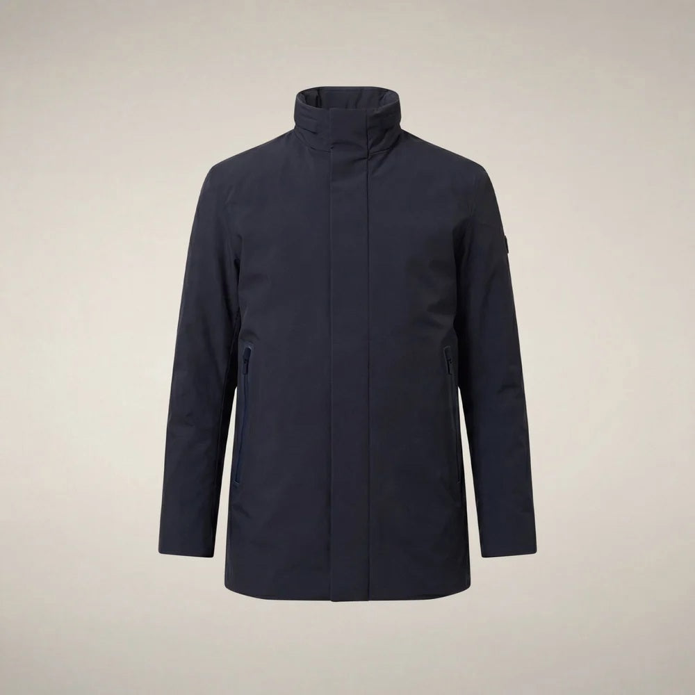A man wears a dark blue SAVE THE DUCK - BLAISE JACKET IN BLUE BLACK with a high neck and a zippered chest pocket.
