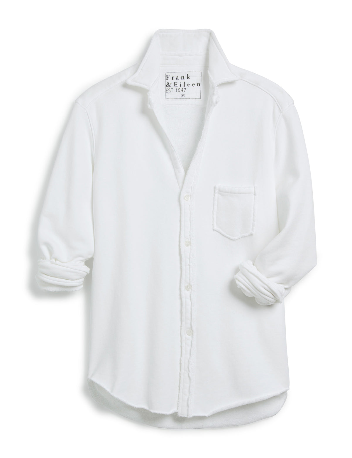 The FRANK AND EILEEN - EILEEN RELAXED BUTTON UP IN TRIPLE FLEECE WHITE features a collared neckline, buttons down the front, and a single chest pocket. The long sleeves are rolled up, and the inside collar label reads &quot;Frank &amp; Eileen EST 1947.&quot; With its relaxed fit and slightly curved hem, it exudes a casual, laid-back vibe.