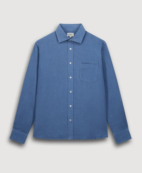 A person with short, curly black hair is seen from behind wearing the HARTFORD - PAUL Linen Shirt in Denim by HARTFORD, set against a plain light background.