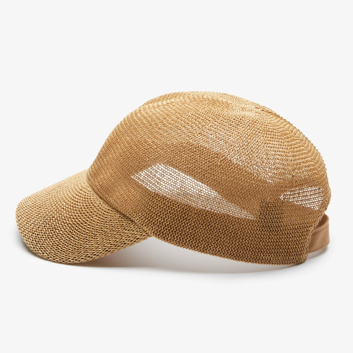 A woman with long wavy blonde hair wears the WYETH HATS - PAULA MESH CAP IN CAMEL by WYETH, featuring UPF 50+ protection, and a white tank top, seated against a plain light-colored background.