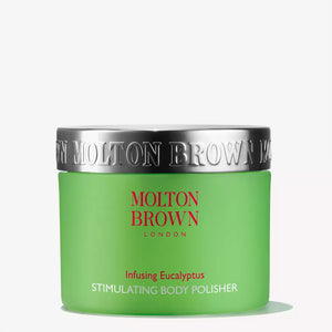 A green jar with a silver lid labeled "MOLTON BROWN - EUCALYPTUS BODY POLISH." The exfoliator's product name appears in red and white text on the jar.