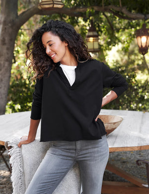 The FRANK & EILEEN PATRICK POPOVER HENLEY in Heritage Jersey Black features a sporty V-neck with a collar and raw-cut hem, set against a light, textured background.