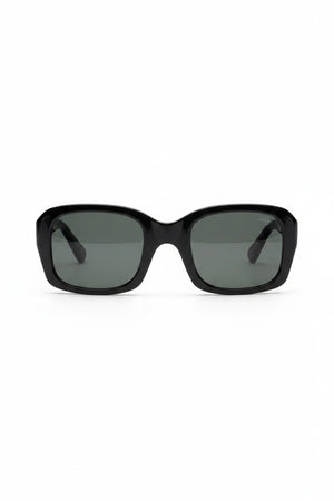 The CADDIS SHELPY Polarized Sunglasses feature a black, oversized square design with dark tinted lenses and a thick, glossy frame for a bold, modern look. Shown from the front on a white background.