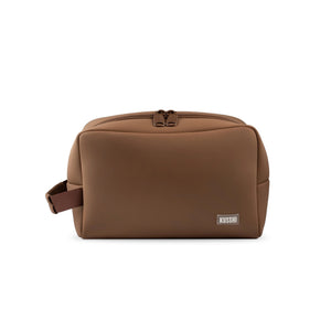 The KUSSHI Neoprene Dopp Kit in Chocolate is a stylish unisex toiletry bag with a blue zipper, perfect for organizing grooming essentials like razors, soap, combs, and lotions while you travel.