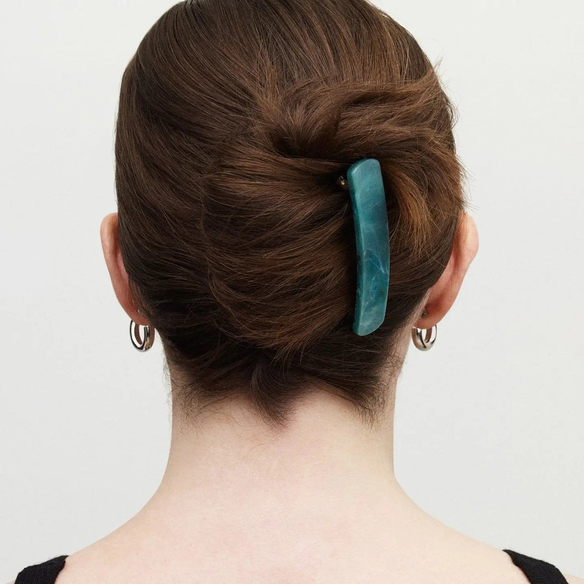 The MACHETE - NO. 3 Heirloom Barrette in Jadeite by MACHETE features a rectangular, rounded-edge handmade design in marbled blue-green cellulose acetate with white streaks, shown on a plain white background.