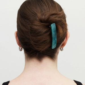 The MACHETE - NO. 3 Heirloom Barrette in Jadeite by MACHETE features a rectangular, rounded-edge handmade design in marbled blue-green cellulose acetate with white streaks, shown on a plain white background.