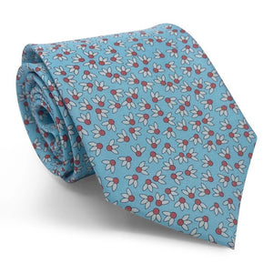 The BIRD DOG BAY PETER-BLAIR Spike Printed Silk Tie in Aqua features a handmade design with a repeating pattern of small white flowers with red centers and gray leaves, shown with its pointed end facing downward.