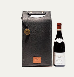 The WILL LEATHER GOODS - DOUBLE LEATHER WINE CASE is a brown full-grain leather tote featuring a top handle cutout, two metal snaps, round metal tag, and stitched "WILL" label—ideal for carrying wine in style.