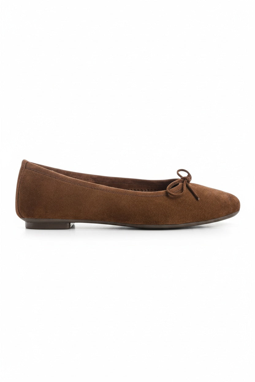 The REQINS HARMONY suede ballerina flats in Cacao, featuring delicate front bows, are shown against a plain light background.