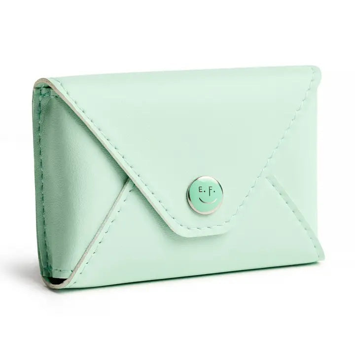 The E. FRANCES PAPER E. FRANNIE PACK, SEAGLASS is a mint green wallet with a snap closure, embossed with "E. FRANCES," ideal for holding Little Notes—perfect as a gift and shown against a white background.
