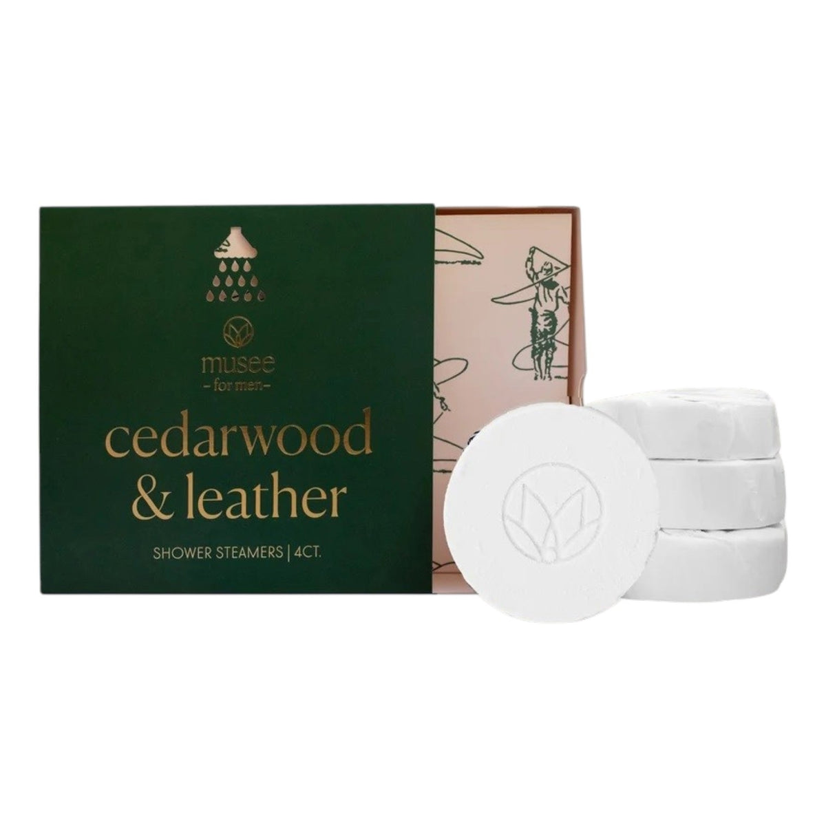 An open green box labeled “MUSEE - CEDARWOOD &amp; LEATHER SHOWER STEAMERS” by MUSEE reveals four round white steamers stacked nearby and inner packaging with illustrations. Each steamer is infused with cedarwood essential oil, transforming your shower into a spa-like retreat.