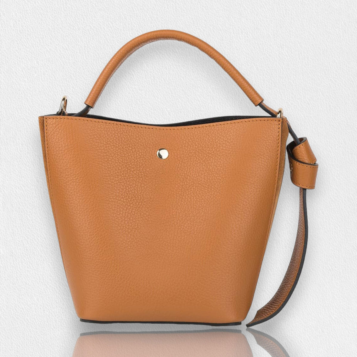 Introducing the SMALL LEATHER BUCKET HANDBAG by LE BORSETTE: This sleek white handbag boasts a structured design with a single top handle and detachable crossbody straps. With its minimalistic style and tiny gold accent on the front, its clean lines and smooth texture provide a modern, sophisticated look.