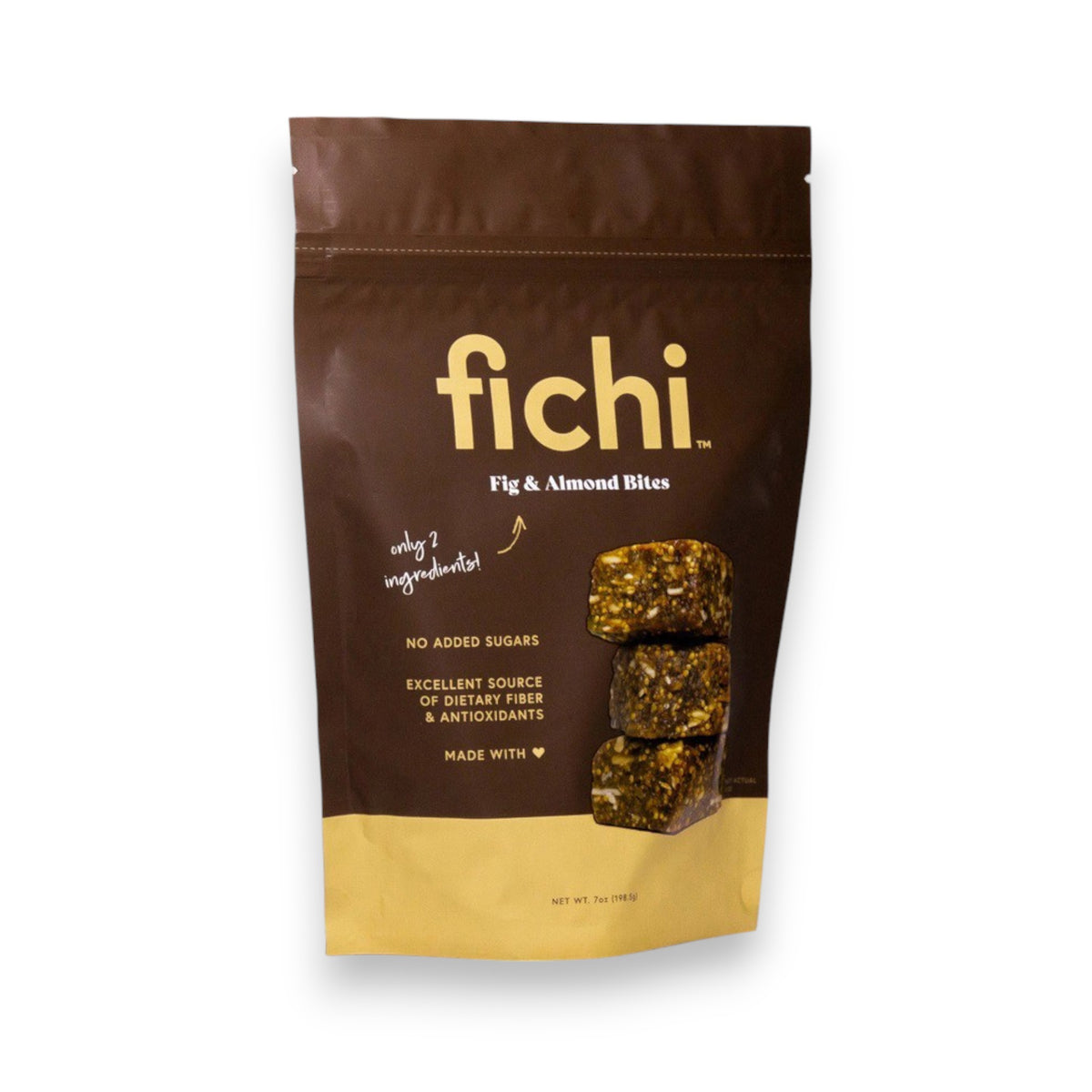 A close-up of a charcuterie board featuring slices of hard yellow cheese, brie cheese, gluten-free FICHI - FIG AND ALMOND BITES from the brand FICHI, and round poppy seed crackers, all beautifully arranged on a white marble and wood serving surface. The board is set on a rustic wooden table.