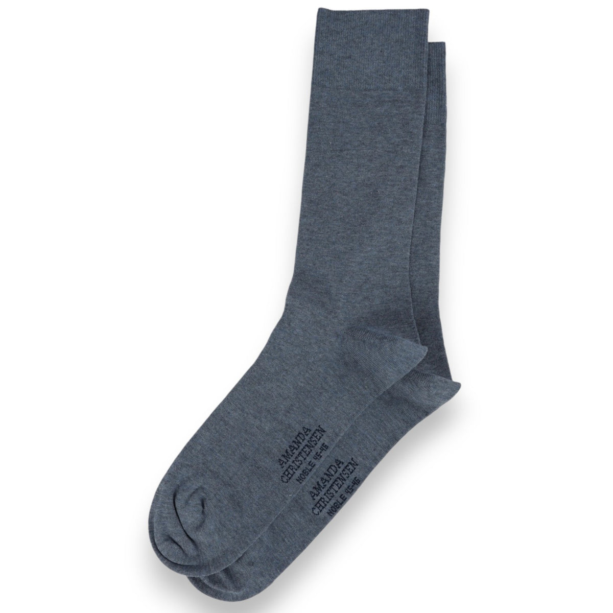 A pair of denim blue, mid-calf socks from AMANDA CHRISTENSEN are laid flat on a white background, with subtle text printed on the sole—these NOBLE Cotton &amp; Cashmere Blend socks embody understated elegance and comfort inspired by classic Scandinavian men’s accessories.
