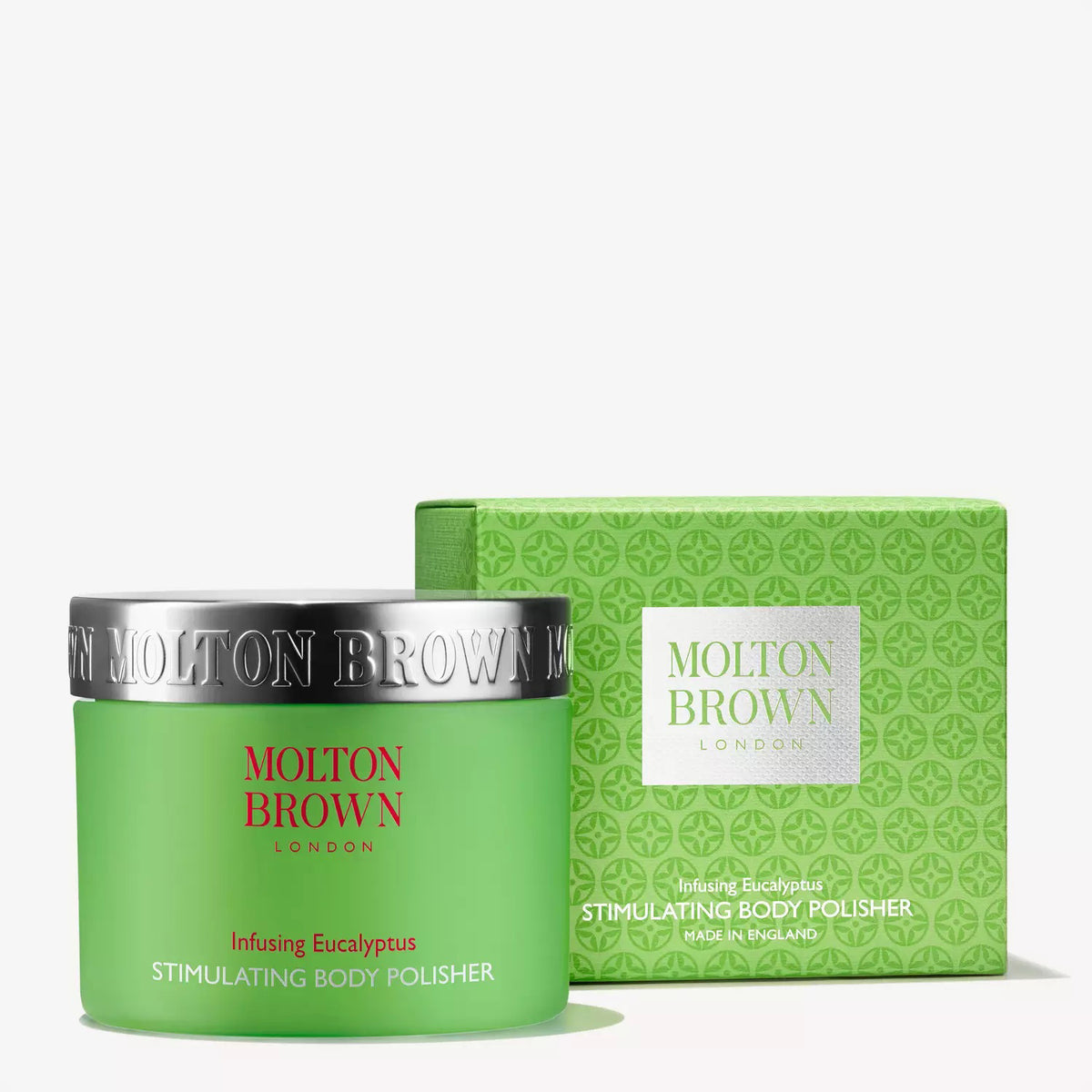 A green jar with a silver lid labeled "MOLTON BROWN - EUCALYPTUS BODY POLISH." The exfoliator's product name appears in red and white text on the jar.