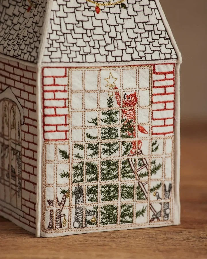HOME FOR THE HOLIDAYS TISSUE BOX COVER shaped like a house, featuring an embroidered Christmas tree, string lights, and a teddy bear in a Santa hat for festive holiday home decor.