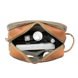 The TSD BRAND Turtle Ridge Toiletry Bag in Olive features leather accents and durable waxed canvas. Grooming essentials fit neatly in elastic loops and mesh pockets, making it the perfect travel companion.