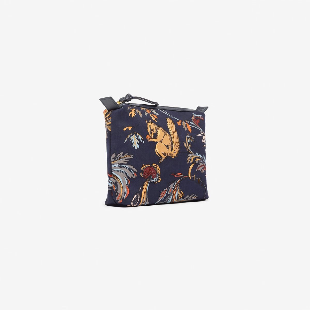 A rectangular zippered cotton case by INOUI, the ROCOCO SQUIRREL CITY CASE features a dark background, colorful rococo-inspired florals, whimsical prints of squirrels, Italian leather accents, and a front &quot;INOUI EDITIONS&quot; label.