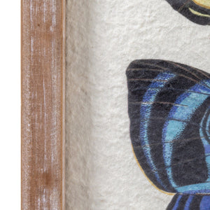 The CREATIVE COOP FRAMED BUTTERFLY ARTWORK displays six colorful butterflies with yellow, blue, brown, and red wings in a circular pattern on a white textured background with a rustic wooden frame—ideal for unique wall décor.