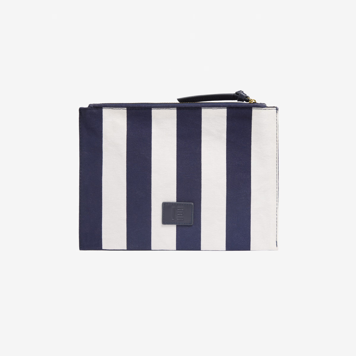 INOUI EDITIONS - POSEIDON POUCH IN NAVY by INOUI features vertical navy and white stripes, a navy zipper, and a small square patch on the front. Inspired by traditional weaving for timeless style, shown against a plain white background.