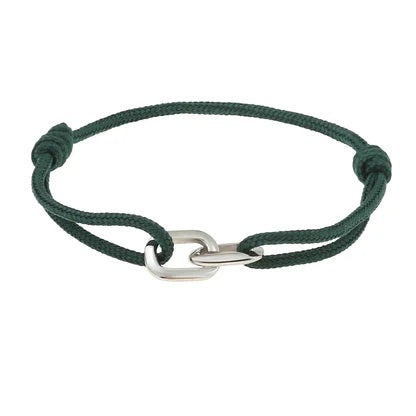 A hand wears the STOLEN RICHES Braga String Bracelet with Linked Chain in green, shown against a light blue shirt and dark pants.