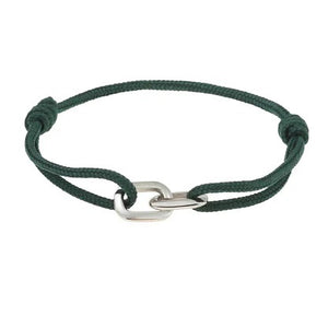 A hand wears the STOLEN RICHES Braga String Bracelet with Linked Chain in green, shown against a light blue shirt and dark pants.