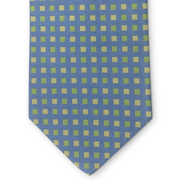 Introducing the PETER-BLAIR - BESPOKE SMALL SQUARES SILK TIE IN BLUE by BIRD DOG BAY: a rolled navy blue woven silk tie, artfully detailed with a pattern of small yellow and green squares on a white background.