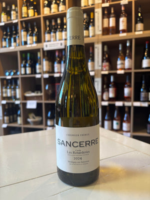 A bottle of CHERRIER FRÈRES 'LES RENARDERIES' SANCERRE 2024 from WINE: KELLOGG SELECTIONS sits on a white counter, with shelves of Loire Valley wine bottles displayed in the background.