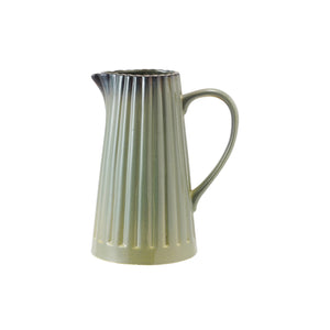 The CREATIVE COOP SAGE GREEN STONEWARE RIBBED PITCHER features a vertical ribbed design, flared spout, and handle. It measures 8.5" high with a 7" wide base, crafted from stoneware with a reactive glaze.