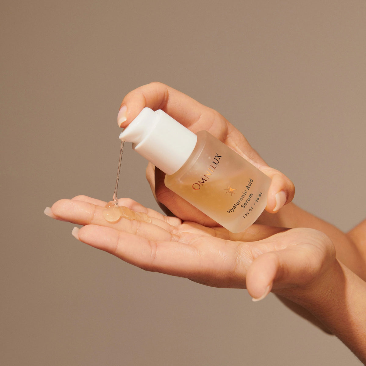 A skincare graphic featuring the OMNILUX - HYALURONIC ACID SERUM, 30ML by OMNILUX spotlights hyaluronic acid for deep hydration, niacinamide to refine skin texture, and licorice root for soothing benefits. The clear gel serum is highlighted with bubbles in the background—ideal for pairing your hyaluronic acid routine with advanced treatments like LED light therapy to achieve radiant results.