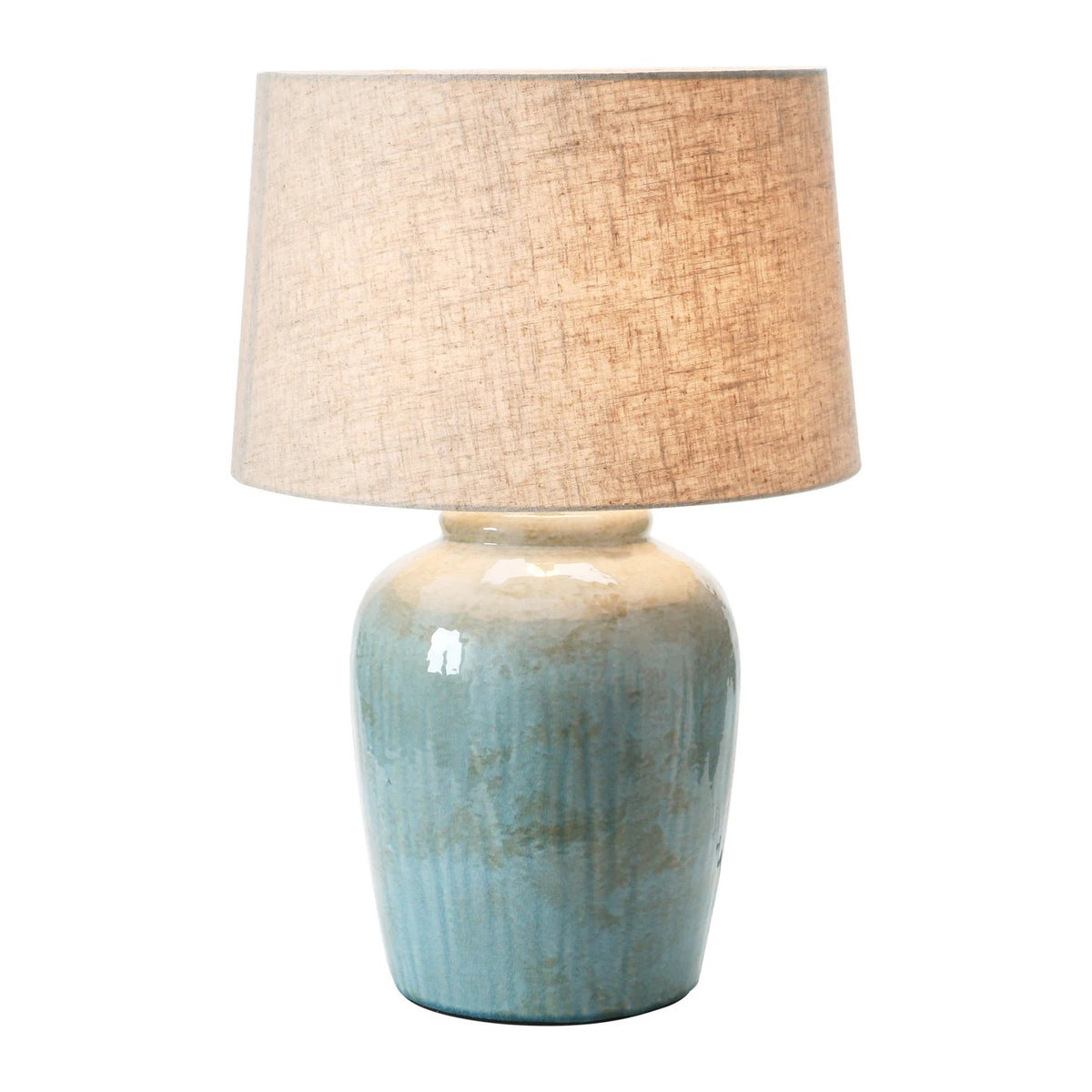 The CREATIVE COOP AQUA STONEWARE LAMP WITH LINEN SHADE features a nature-inspired design with a muted green textured ceramic base and a beige linen shade, set against a white background.