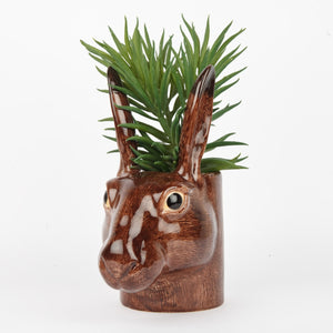 The QUAIL DESIGNS QUAIL CERAMICS - HARE PENCIL POT is a 15 cm hand-painted stoneware pencil holder shaped like a brown hare's head with textured fur, upright ears, and glossy finish. Dishwasher safe and shown on a plain white background.