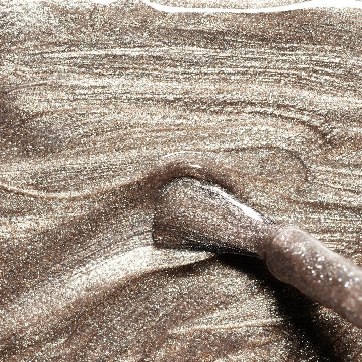 Discover nine vegan nail polish swatches from MANUCURIST INC, including the GREEN™ NAIL POLISH IN METALLIC, along with shades like Mermaid, Nebula, Disco, Moon, Diamant, Quartz, Fairy, Tweed, and Pearlescent. Each features shimmery or pearly finishes in a range of vibrant colors. These non-toxic polishes include striking iridescent gold effects for a glamorous manicure.