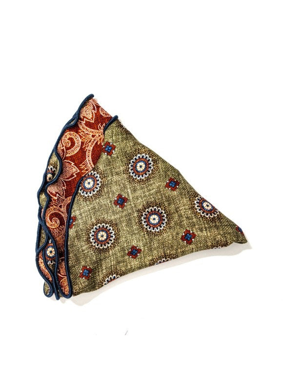 The EDWARD ARMAH Silk Reversible Pocket Circle in Olive Medallion features a greenish-brown base with medallion floral prints, a visible red section with detailed patterns, and dark blue edging.