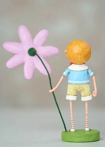 The 7&quot; Billy Bloom Figurine by ESC and Company, Inc. showcases a rosy-cheeked child in a blue top and striped shorts, holding a big pink flower. Crafted from durable poly resin, it stands on a green base set against a neutral background.