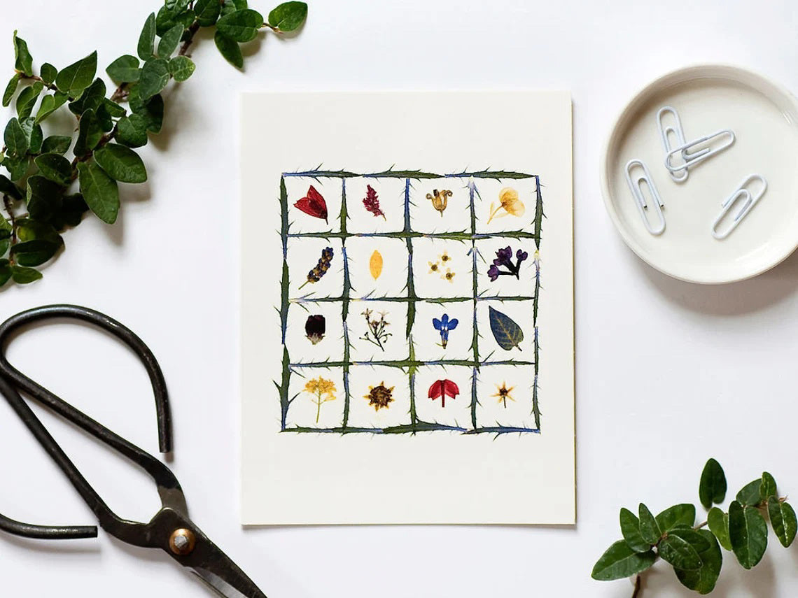 The PETAL PEOPLE PRESS - FLOWER QUILT CARD by PETAL PEOPLE PRESS features a grid of green stems filled with vibrant pressed flowers and leaves on a white background—a beautiful botanical design ideal for any blank notecard.