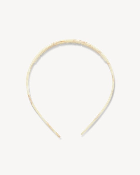 The MACHETE Ultralight Thin Headband in Creme is a sleek, lightweight Italian acetate accessory featuring a subtle marbled pattern in a creamy hue, shown against a plain white background.