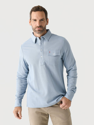 A smiling man with short blond hair and a beard wears the CRIQUET Long Sleeve Players Polo Shirt in Mr Freeze, standing against a plain white background.