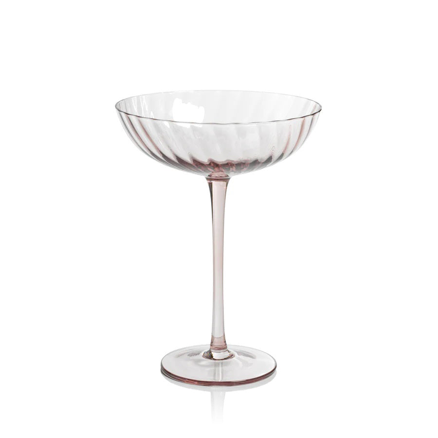 The SAVOY OPTIC SWIRL COCKTAIL GLASS by ZODAX features a clear, elegantly designed coupe with a subtle optic swirl pattern. Resting on a slender stem and circular base, this minimalist and sophisticated glass is perfect for serving cocktails or champagne.