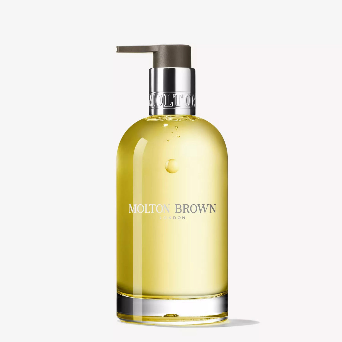 A clear glass bottle of MOLTON BROWN ORANGE &amp; BERGAMOT HAND WASH with a silver pump and "MOLTON BROWN LONDON" on the front, displayed against a plain white background.