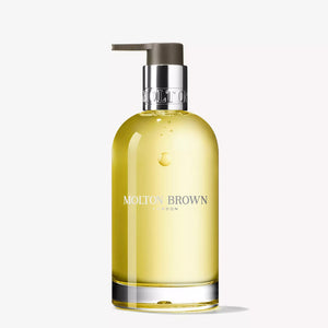 A clear glass bottle of MOLTON BROWN ORANGE & BERGAMOT HAND WASH with a silver pump and "MOLTON BROWN LONDON" on the front, displayed against a plain white background.