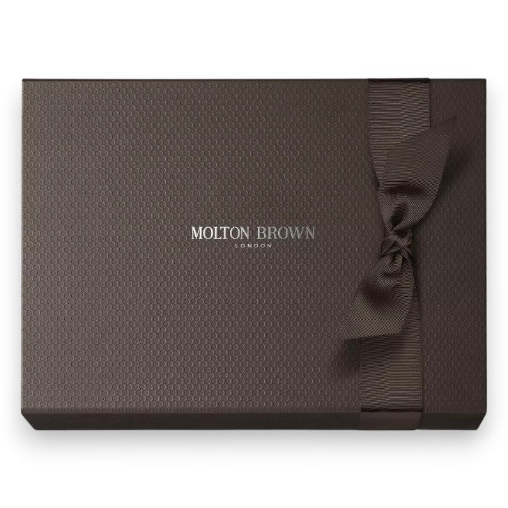 The MOLTON BROWN - BLUEBELL FRAGRANCE LAYERING GIFT SET features a Bluebell &amp; Wild Strawberry body wash, a white lotion bottle with pump, and a slim fragrance spray—elegantly presented on a white textured background.