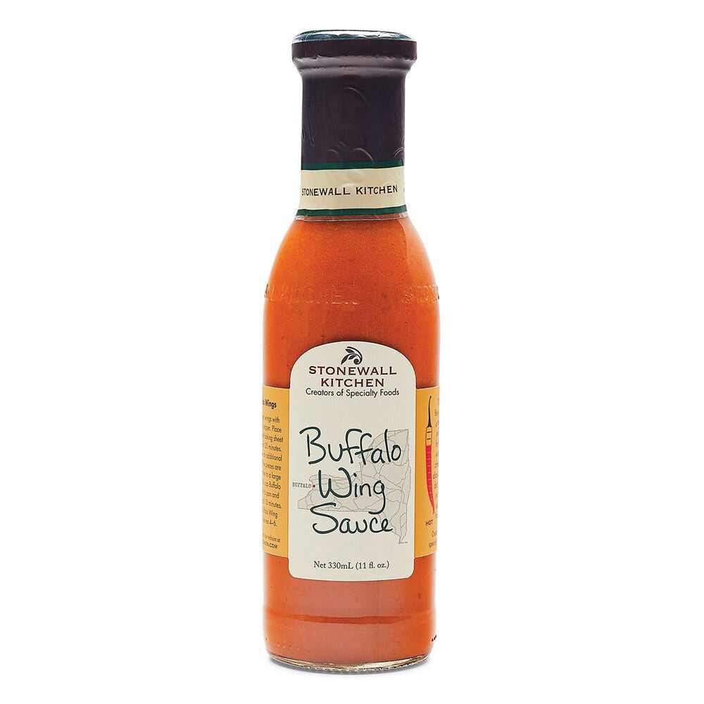 A bottle of STONEWALL KITCHEN - BUFFALO WING SAUCE from STONEWALL KITCHEN, made with fiery cayenne peppers, features an orange-red liquid, a beige cap, and a white label showing the product name.
