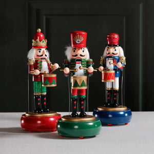 The ZODAX NUTCRACKER MELODY MUSIC BOX features festive nutcrackers in assorted styles, each with unique accessories. Sold individually; call store for details. Each stands next to a tall red gift box with a green and gold label.